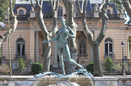 Olot statue in front of French style house