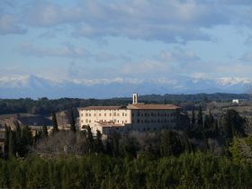 convent in La Bisbal from path close to Fonteta with mountains in the distance