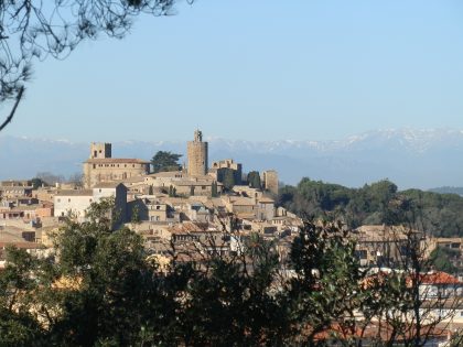 Pals village in the Costa Brava with snow on the Pyrenees behind taken from Quermany Petit