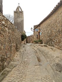 Cart tracks worn into the rock in Peratallada