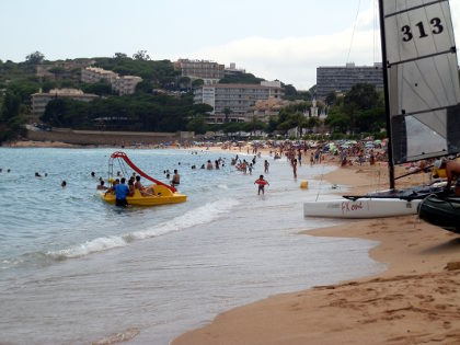Sant Pol beach with bay and boating activities